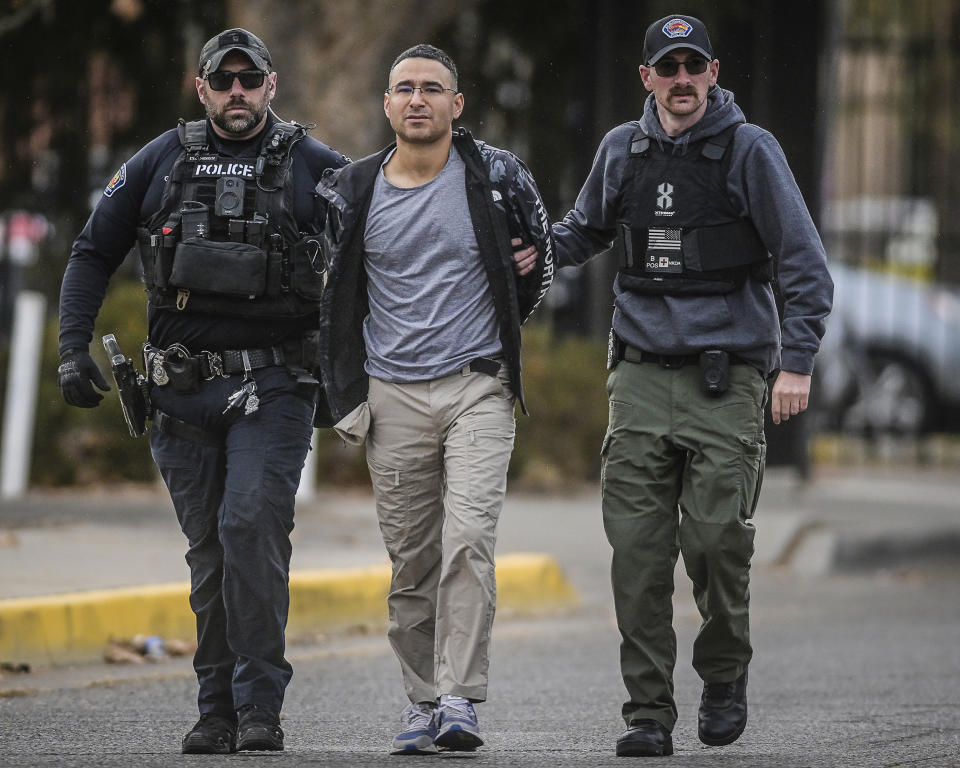 Solomon Pena, center, a Republican candidate for New Mexico House District 14, is taken into custody by Albuquerque Police officers, on Jan. 16, 2023, in southwest Albuquerque, N.M. (Roberto E. Rosales / The Albuquerque Journal via AP)