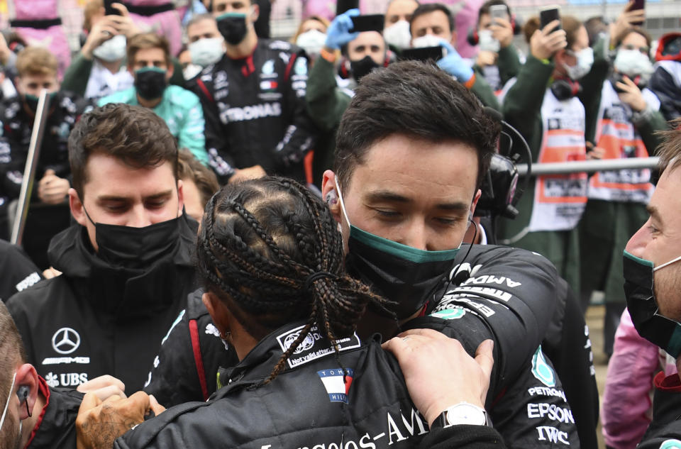 Mercedes driver Lewis Hamilton of Britain celebrates with his team after winning the Turkish Formula One Grand Prix at the Istanbul Park circuit racetrack in Istanbul, Sunday, Nov. 15, 2020. (Clive Mason/Pool via AP)