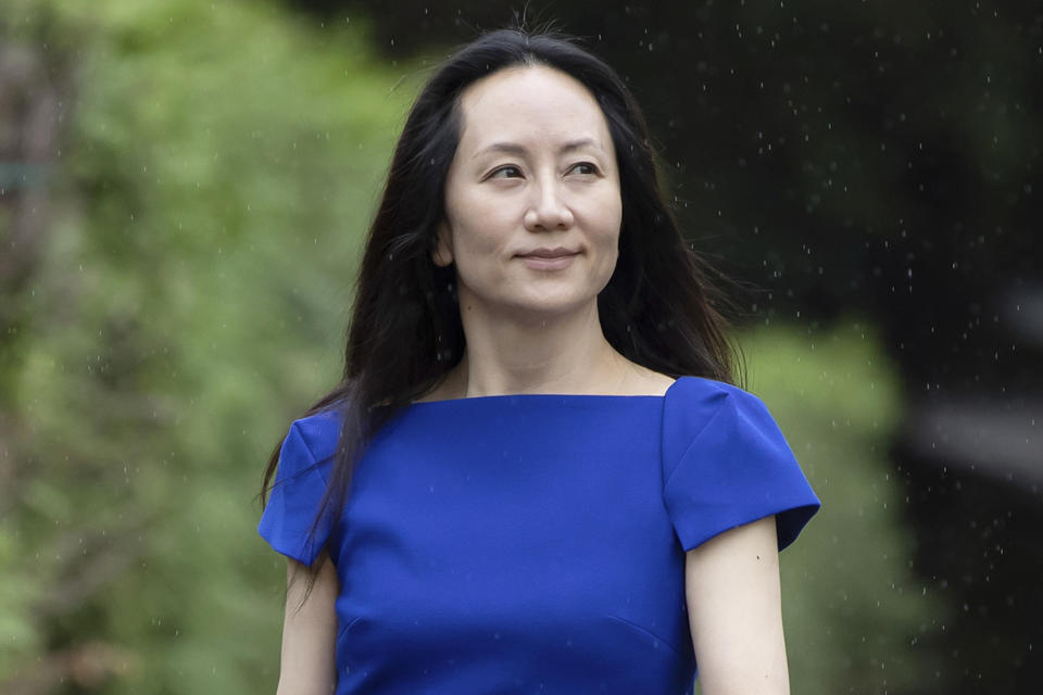 FILE- Meng Wanzhou, chief financial officer of Huawei, leaves home to attend her extradition hearing at B.C. Supreme Court, in Vancouver, British Columbia, Monday, Aug. 16, 2021. The Canadian government has reached a settlement with Michael Spavor, one of two Canadians who were detained in China for nearly three years on national security charges. The Canadian government has long maintained that Spavor and Michael Kovrig were held to pressure Canada to release Meng Wanzhou, a senior executive of Chinese tech firm Huawei Technologies, who had been detained in December 2018 at the request of U.S. authorities who wanted her to face charges in America. (Darryl Dyck/The Canadian Press via AP, File)