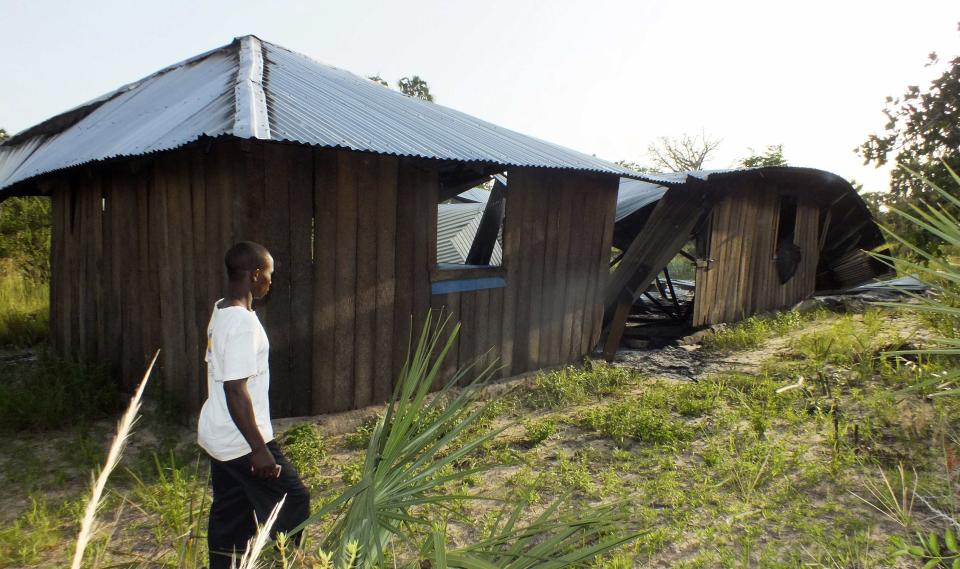 A resident looks at a church destroyed after gunmen attacked Hindi village, near Lamu