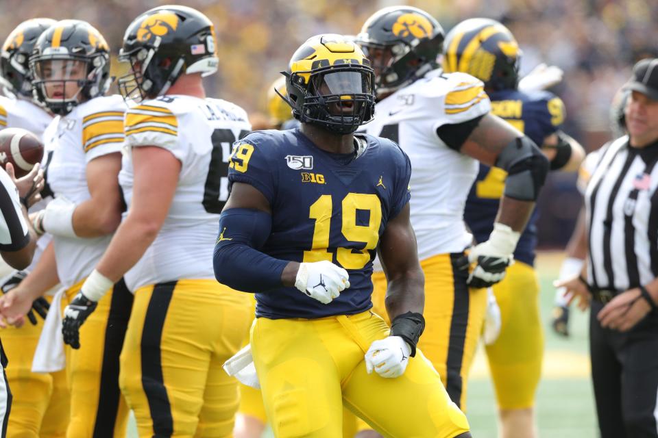 Michigan Wolverines defensive lineman Kwity Paye celebrates his sack against the Iowa Hawkeyes during the first half Saturday, Oct. 5, 2019 at Michigan Stadium in Ann Arbor.