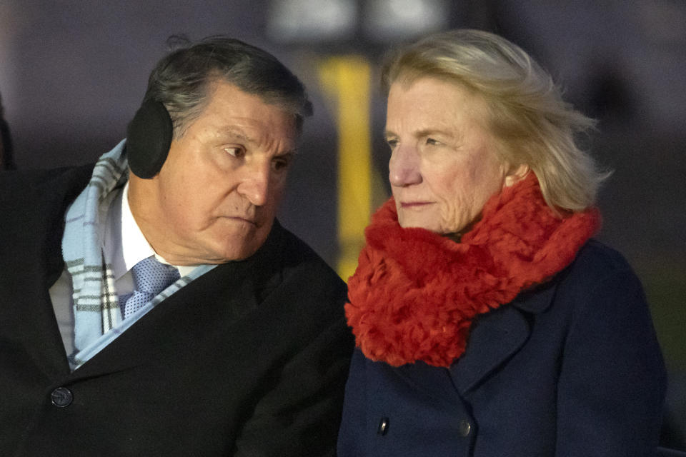 FILE - Sen. Joe Manchin, D-W.Va., left, and Sen. Shelley Moore Capito, R-W.Va., sit during the U.S. Capitol Christmas tree lighting ceremony on the West Front of the Capitol, Tuesday, Nov. 28, 2023 in Washington. Now at the end of his second term as a U.S. senator, Manchin is still not a declared candidate for any office five months before the 2024 general election. But there’s still time to mull potential runs for governor, the Senate, and even the U.S. presidency. (AP Photo/Mark Schiefelbein, File)