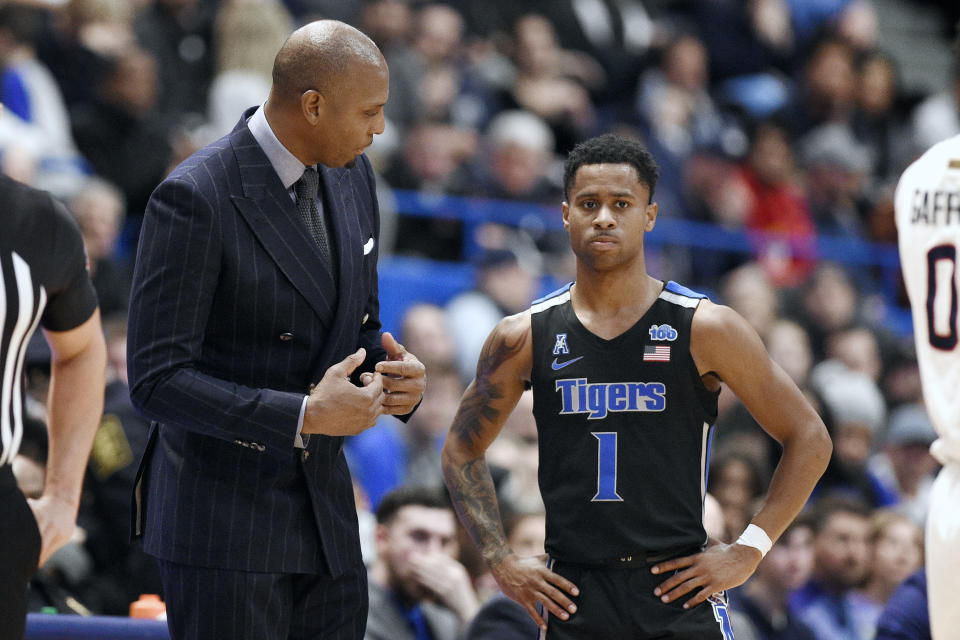 Memphis head coach Anfernee "Penny" Hardaway, left, talks with Tyler Harris, right, in the second half of an NCAA college basketball game, against Connecticut, Sunday, Feb. 16, 2020, in Hartford, Conn. (AP Photo/Jessica Hill)