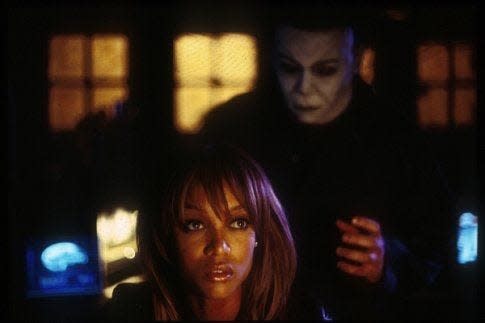 Michael Myers sneaks up on Nora Winston (Tara Banks) in "Halloween: Resurrection"  when his childhood home is used for a live internet horror show.  Released in 2002 by Dimenstion Films,  the film also stars Jaime Lee Curtis, Busta Rhymes, Thomas Ian Nicholas, Ryan Merriman and Sean Patrick Thomas.