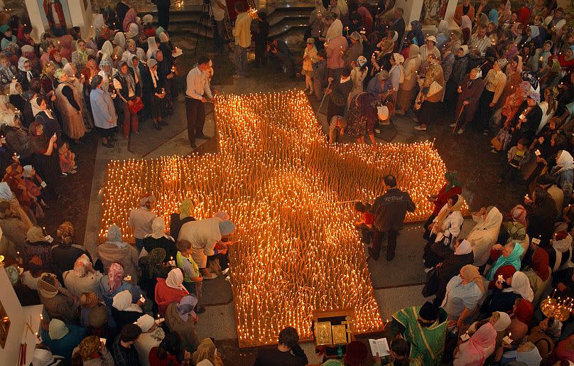 People light candles during an anti-abortion service in an Orthodox church in Vladivostok, Russia