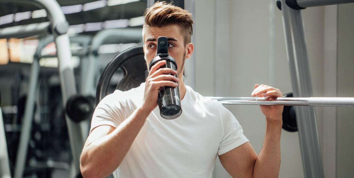 handsome man resting during a workout at the gym