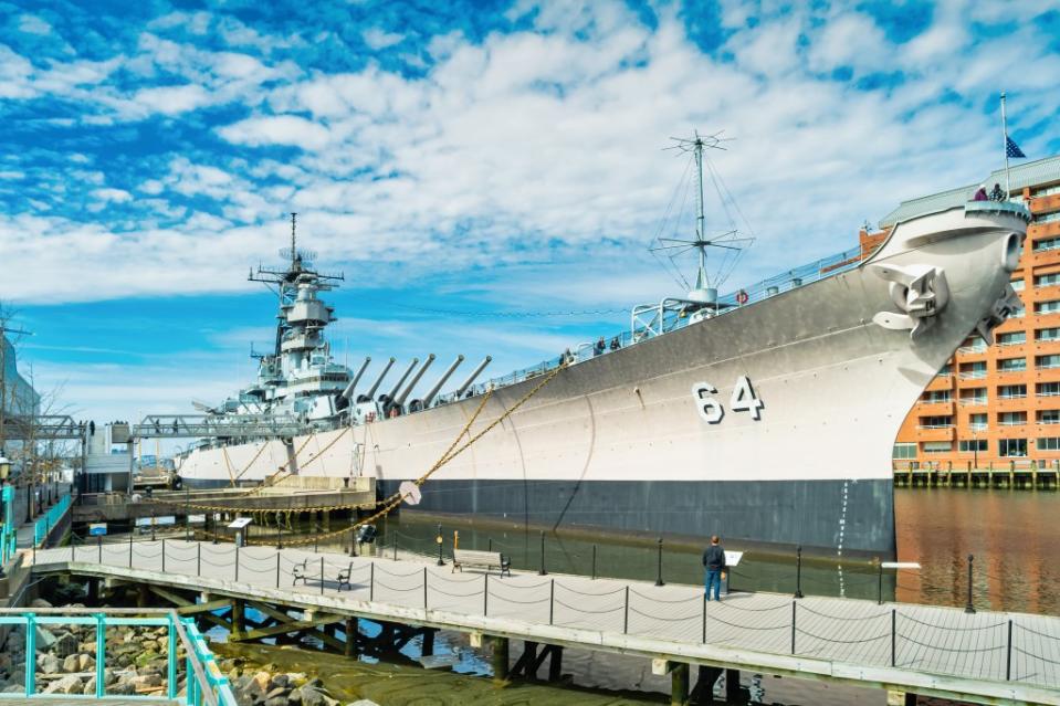 People visit the USS Wisconsin battleship, located at the Nauticus Museum in downtown via Getty Images