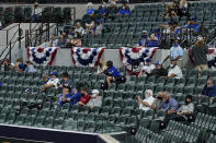 Fans watch during the second inning in Game 1 of a baseball National League Championship Series between the Los Angeles Dodgers and the Atlanta Braves Monday, Oct. 12, 2020, in Arlington, Texas. (AP Photo/Tony Gutierrez)