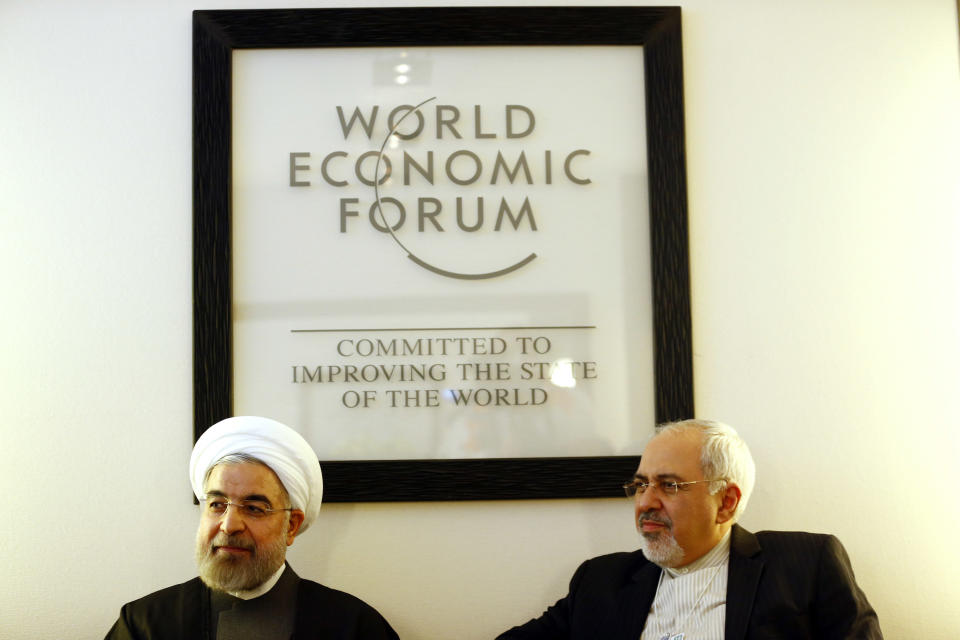 Iranian President Hassan Rouhani, left, and and his Foreign Minister Mohammad Javad Zarif, meets founder and President of the World Economic Forum in Davos, Switzerland, Wednesday, Jan. 22, 2014. Leaders gathered in the Swiss ski resort of Davos have made it a top priority to push to reshape the global economy and cut global warming by shifting to cleaner energy sources. (AP Photo/Denis Balibouse, Pool)