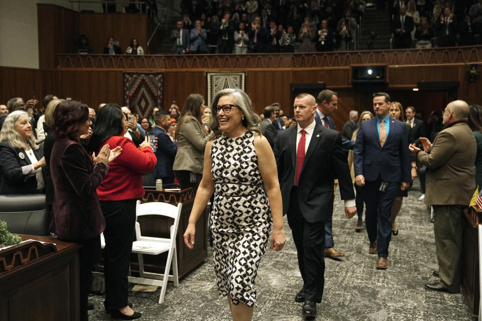 Arizona Democratic Gov. Katie Hobbs smiles as she arrives on the House of Representatives floor to deliver the State of the State address at the Arizona state capitol Monday, Jan. 8, 2024, in Phoenix. (AP Photo/Ross D. Franklin)