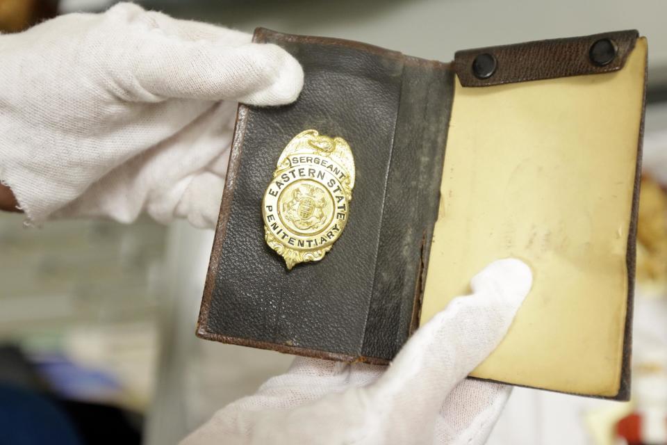 In this Tuesday, March 12, 2013 photo, shown is a jailers badge at the Eastern State Penitentiary in Philadelphia. The defunct and decayed prison that serves as one of Philadelphia's quirkiest tourist attractions, plans to displaying dozens of never-before-seen artifacts for 10 days only in a "pop-up museum." (AP Photo/Matt Rourke)