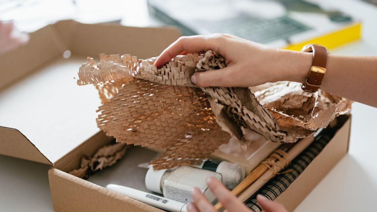 anonymous woman unwrapping the gift box