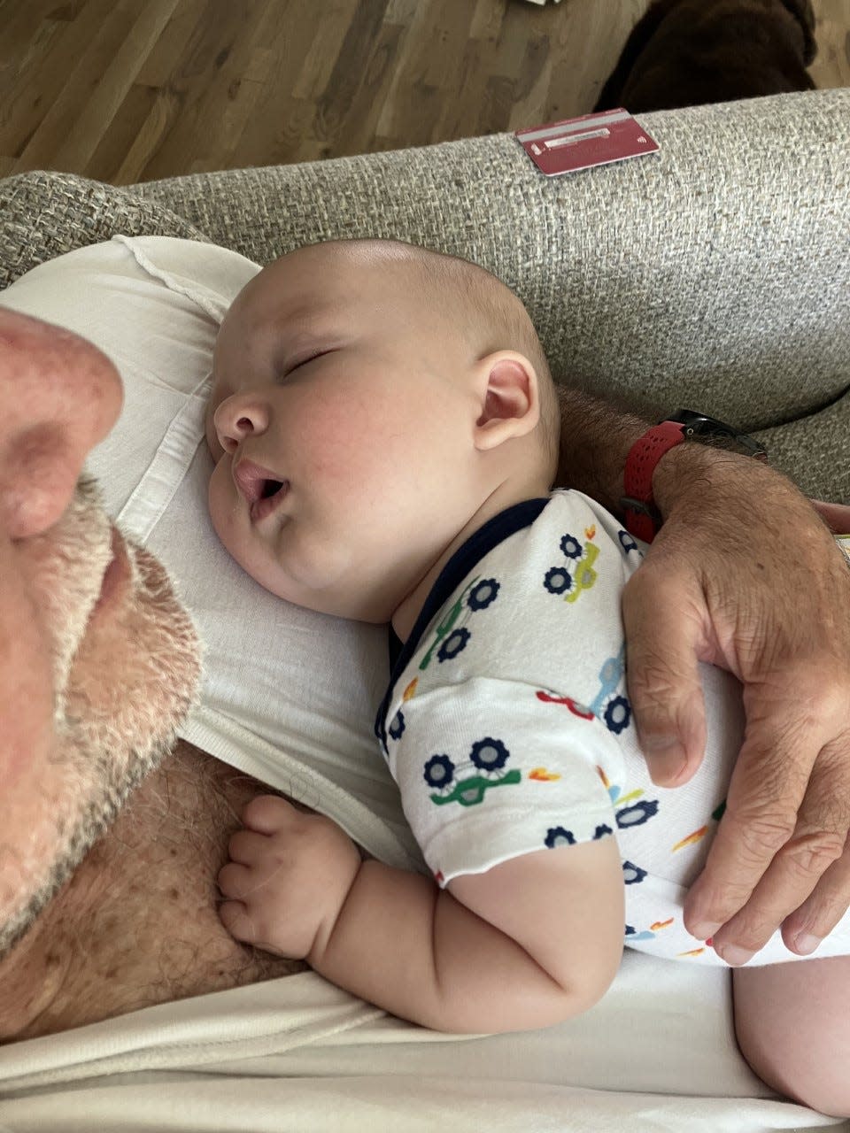 Clay William Osborne takes a snooze in the arms of his grandfather, Gazette columnist Bill Poteat.