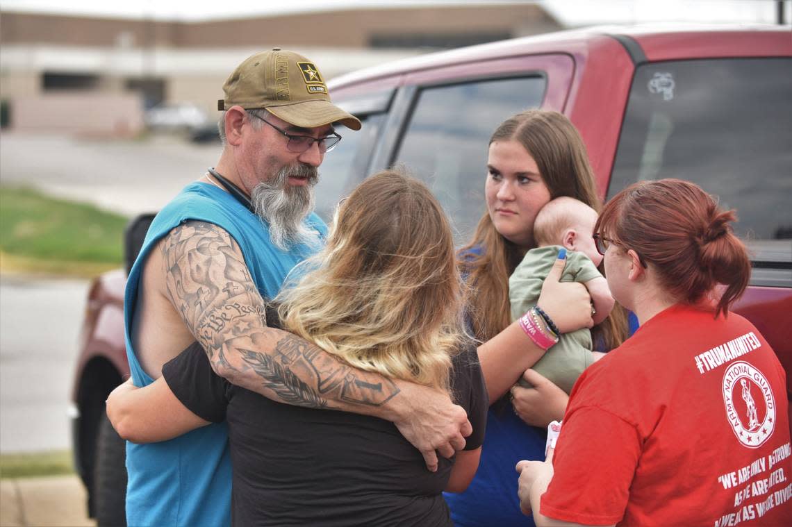 Members of the Chafa family embrace as they reunite outside of Independence Center Mall, where police were investigating after a person fired gunshots inside on Labor Day afternoon. No one was injured during the shooting, according to Independence police.