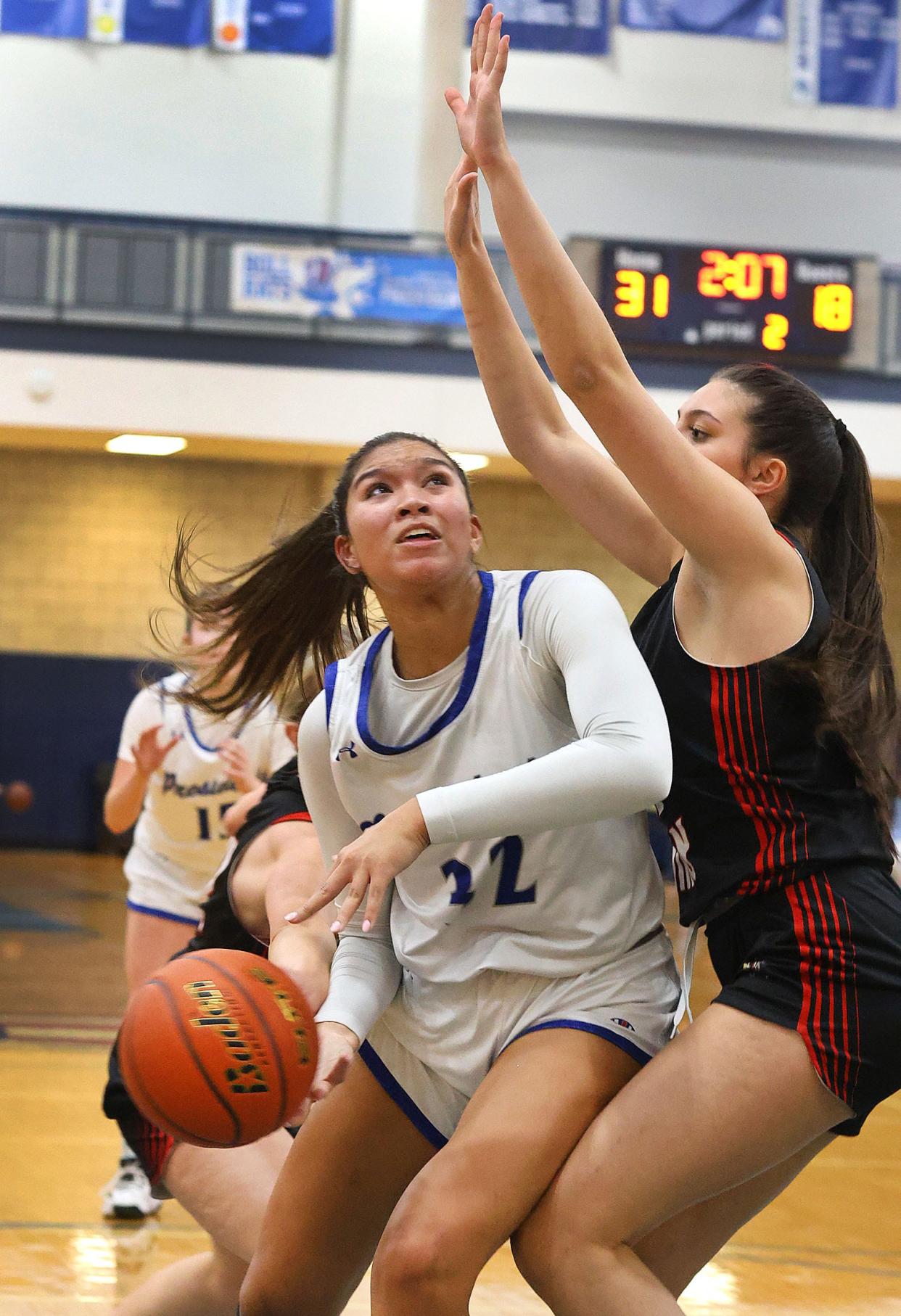 Alyssa Hopps works under the basket and Raiders guard Autumn O'Campos.

The Quincy High girls basketball hosts North Quincy High on Friday Feb. 9, 2024