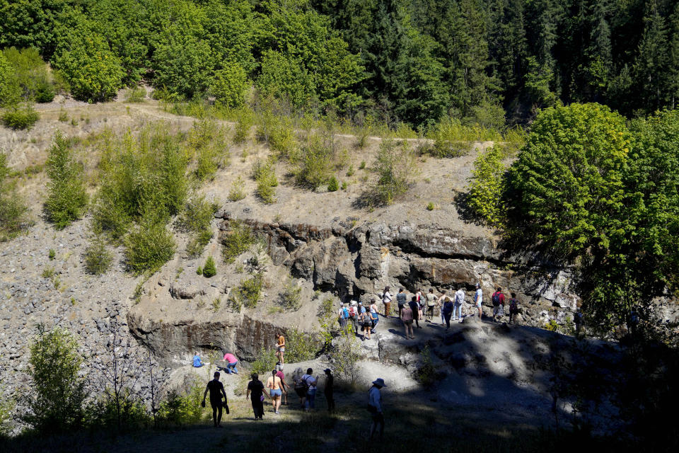 Campers overlook the Elwha River at the former Elwha Dam site during the 2023 Tribal Climate Camp on the Olympic Peninsula Wednesday, Aug. 16, 2023, near Port Angeles, Wash. Participants representing at least 28 tribes and intertribal organizations gathered to connect and share knowledge as they work to adapt to climate change that disproportionally affects Indigenous communities. More than 70 tribes have taken part in the camps that have been held across the United States since 2016. (AP Photo/Lindsey Wasson)