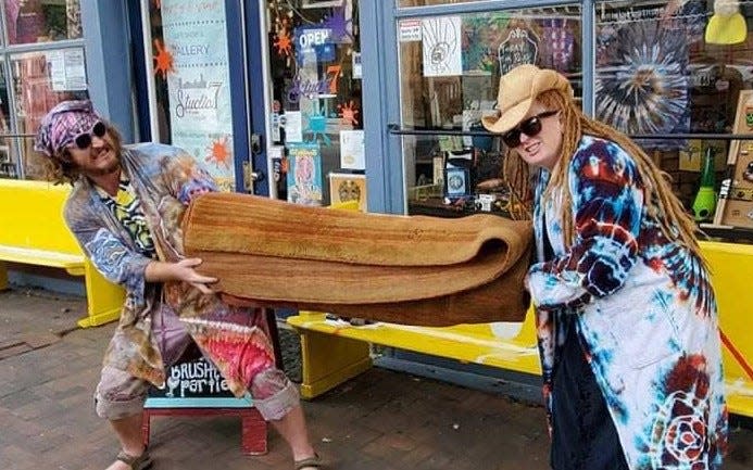 'The Big Lebowski' fans Old Towne Studio7 owner Denise Tipton and Dirty Dan's Hippie Haven owner Dan Waterland wear tie-dyed robes to prepare for The Big LeBYRDski Fest. 'All the dude ever wanted was his rug back, man. It really tied the room together' - The Dude