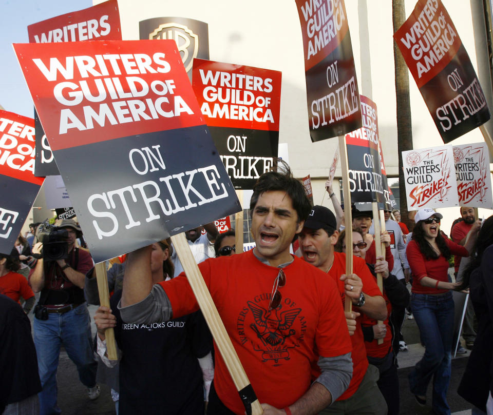 FILE - Actor John Stamos, center, and other cast members of the Emmy-winning television serial medical drama "ER", support members of the Writers Guild of America, as they strike outside the Warner Bros. Television Studios in Los Angeles on Nov. 6, 2007. (AP Photo/Damian Dovarganes, File)