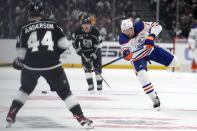 Edmonton Oilers defenseman Vincent Desharnais, right, passes the puck while under pressure from Los Angeles Kings defenseman Mikey Anderson aduring Game 3 of an NHL hockey Stanley Cup first-round playoff series Friday, April 26, 2024, in Los Angeles. (AP Photo/Mark J. Terrill)