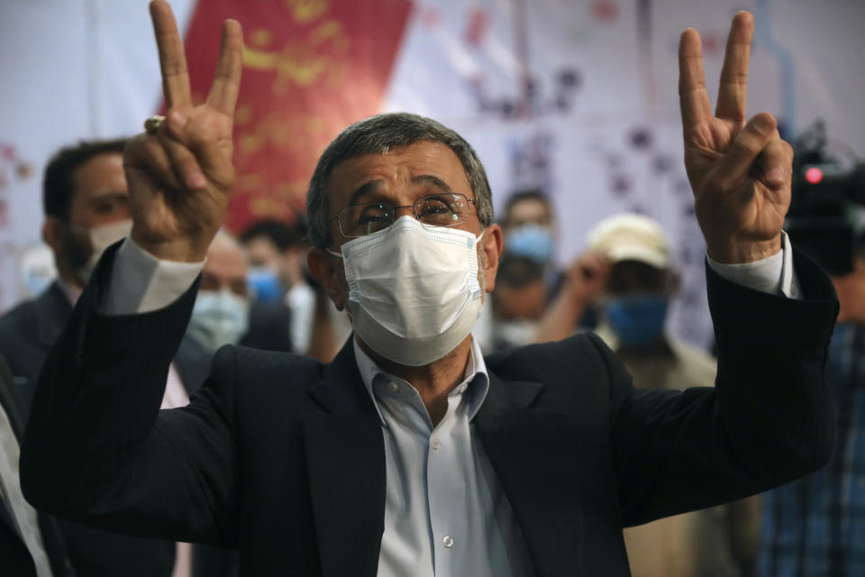 Former President Mahmoud Ahmadinejad flashes victory sign while registering his name as a candidate for the June 18, presidential elections at elections headquarters of the Interior Ministry in Tehran, Iran, Wednesday, May 12, 2021. The country's former firebrand president will run again for office in upcoming elections in June. The Holocaust-denying Ahmadinejad has previously been banned from running for the presidency by Supreme Leader Ayatollah Ali Khamenei in 2017, although then, he registered anyway. (AP Photo/Vahid Salemi)