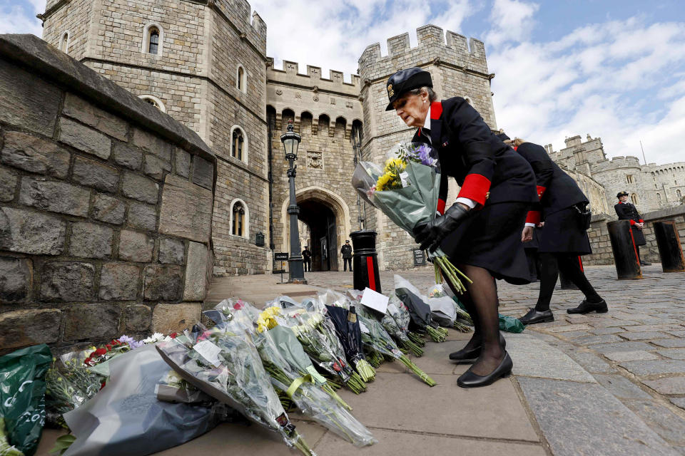 Image: Wardens of the Castle move floral tributes to the side of the driveway at the Henry VIII Gate of Windsor Castle, in Windsor, west of London (Adrian Dennis / AFP - Getty Images)