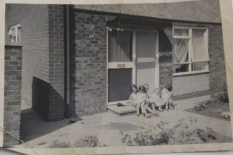 Paula and Michelle Murphy and friends on the front step of their home on Braemar Grove, Darnhill in the late 1960s