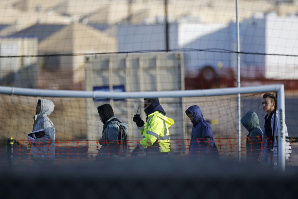 File - In this Dec. 13, 2018, file photo, teen migrants walk in line inside the Tornillo detention camp in Tornillo, Texas. A federal judge says he will give the Trump administration six months to identify children who were separated from their families at the U.S.-Mexico border early in the president's term. U.S. District Judge Dana Sabraw said Thursday, April 25, 2019, in San Diego that it was important to set a deadline for finding potentially thousands of children who were separated between July 1, 2017, and June 25, 2018. (AP Photo/Andres Leighton, File)