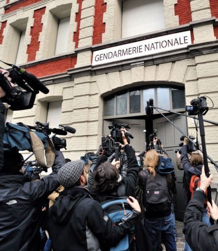 Journalists film and take pictures of Dominique Strauss-Kahn arriving by car at the police station in Lille, northern France. French police have detained Strauss-Kahn for questioning over allegations he took part in orgies in Paris and Washington with prostitutes paid for by businessmen