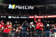 New Jersey Devils fans celebrate after the team scored in the second period of an NHL Stadium Series hockey game against the Philadelphia Flyers in East Rutherford, N.J., Saturday, Feb. 17, 2024. (AP Photo/Peter K. Afriyie)