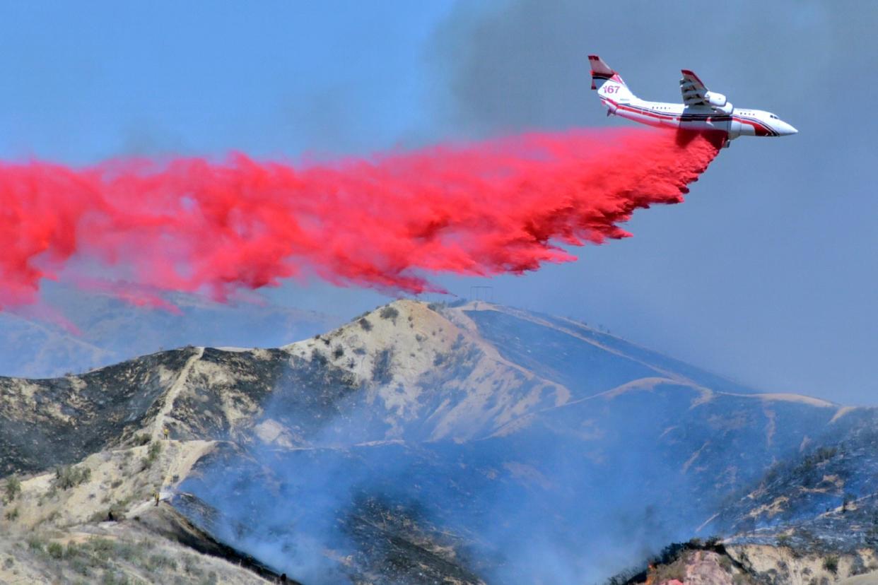 <p>More droughts and heatwaves have increased likelihood of wild fires across the US</p> (AP)