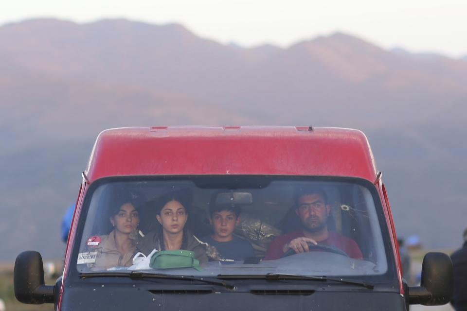 Ethnic Armenians from Nagorno-Karabakh sit inside a minibus on their way to Armenia's Goris in Syunik region, Armenia, on Thursday, Sept. 28, 2023. Armenian officials say more than 70% of Nagorno-Karabakh's original population have fled the region for Armenia. (Vahan Stepanyan, PAN Photo via AP)