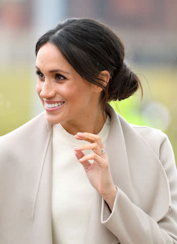 <p>Dubbed the queen of the bun, Meghan surprised royal fans by wearing her go-to messy bun once more (despite criticism from the public) on her debut trip to Belfast. (Photo: Getty Images) </p>