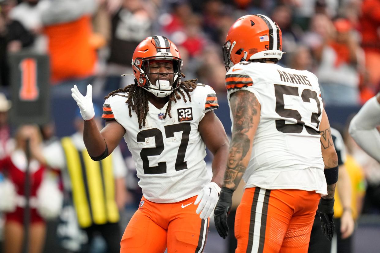 Cleveland Browns running back Kareem Hunt (27) celebrates his touchdown with center Nick Harris (53) against the Houston Texans on Dec. 24, 2023, in Houston.