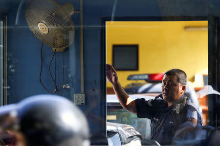 A police officer stands outside the morgue at Kuala Lumpur General Hospital where Kim Jong Nam's body is held for autopsy in Malaysia February 17, 2017. REUTERS/Athit Perawongmetha