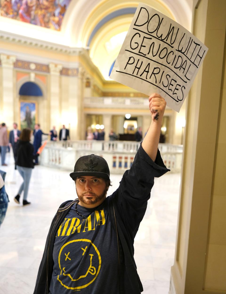 Chase Brody holds a sign Tuesday during a protest in solidarity with Trans Oklahomans outside of the House chambers during debate on a bill to limit gender transition procedures.