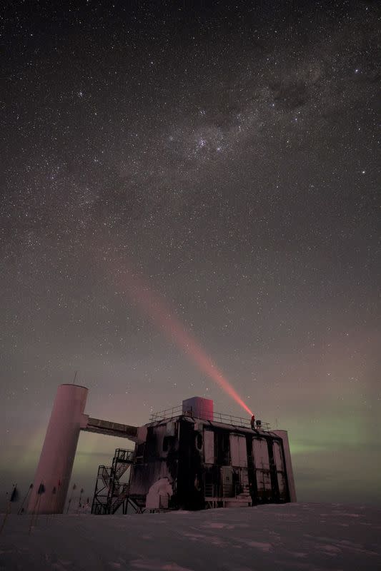 View of the IceCube Lab at the South Pole with a starry sky above