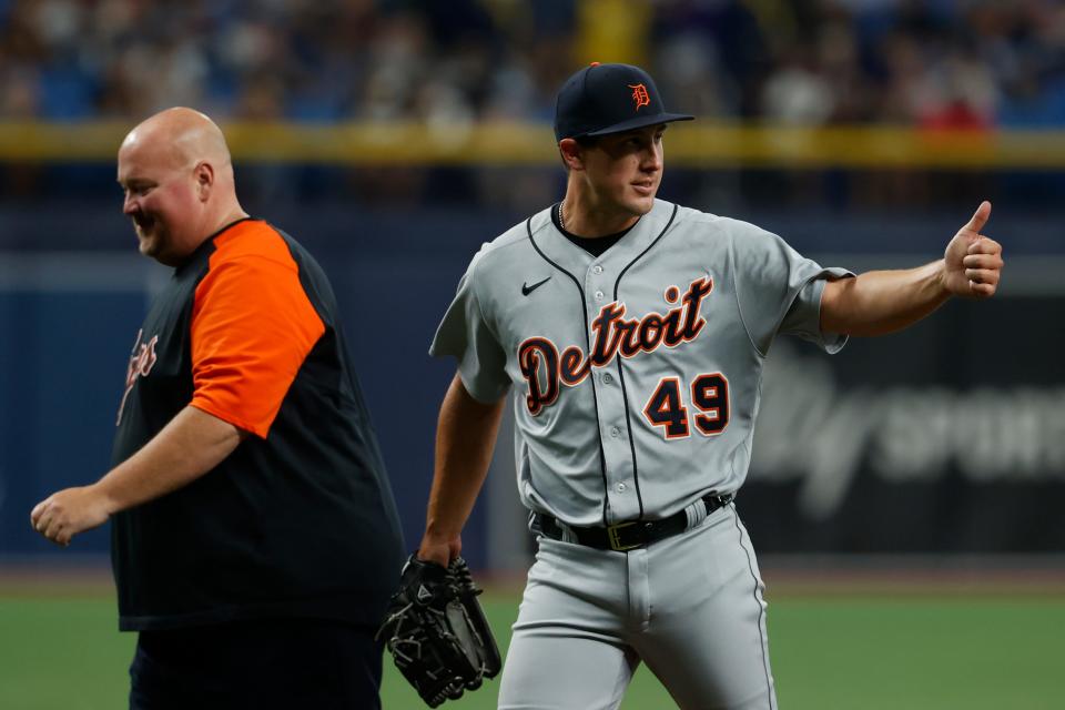 Detroit Tigers relief pitcher Derek Holland (49) gives a thumbs-up signal while leaving the game against the Tampa Bay Rays during the fifth inning  Friday, Sept. 17, 2021, in St. Petersburg, Fla.