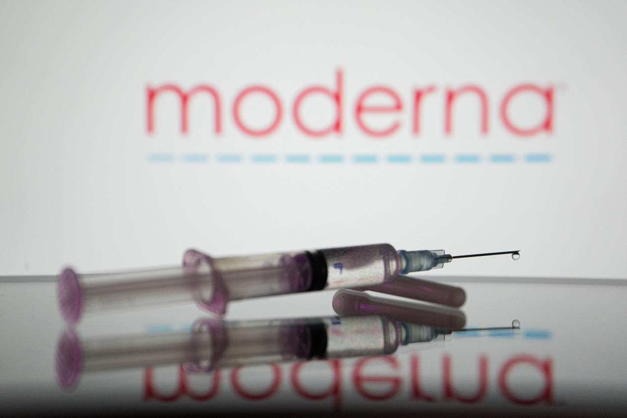 GREECE - 2022/03/29: In this photo illustration, a medical syringe is displayed on a screen, and the logo of Moderna in the background. (Photo Illustration by Nikos Pekiaridis/SOPA Images/LightRocket via Getty Images)