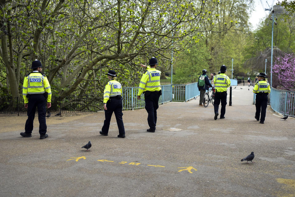 Police officers patrol St James's Park, during lockdown due to the coronavirus outbreak, in London, Thursday, April 16, 2020. The British government is promising to test thousands of nursing home residents and staff for the new coronavirus, as it faces criticism for failing to count care-home deaths in its tally of victims. (AP Photo/Alberto Pezzali)