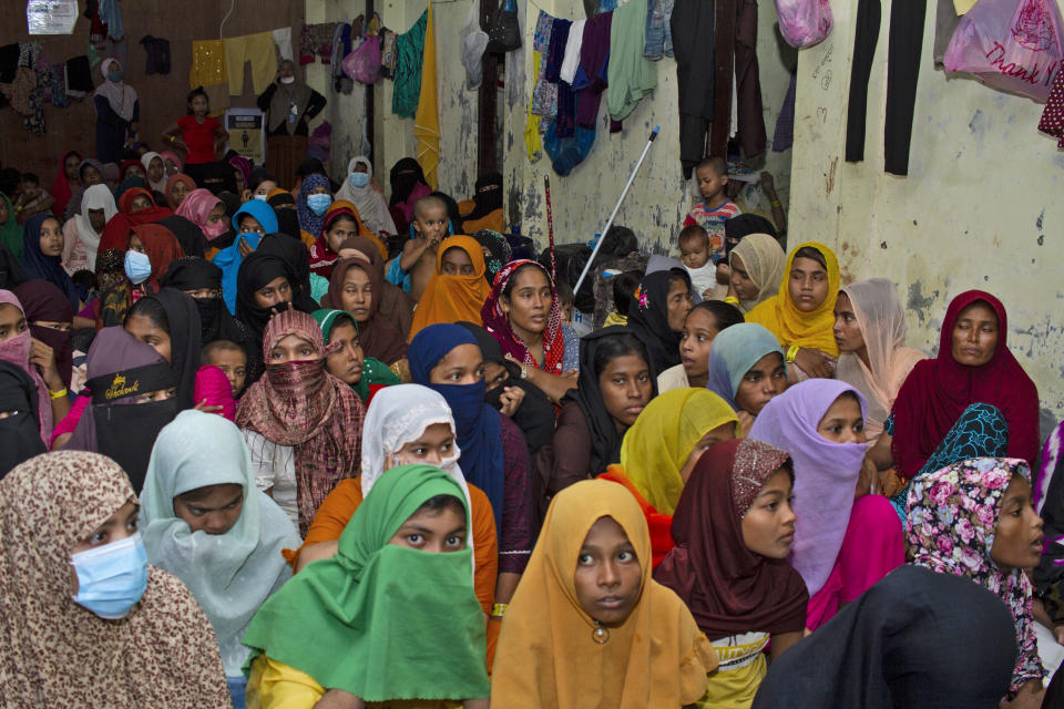 Rohingya women sit inside a shelter in Lhokseumawe, Aceh province, Indonesia, Tuesday, Dec. 12, 2023. Indonesia urges more resettlement for the Rohingya Muslims refugees following the increased number of the refugees that arrived in Indonesia's province Aceh in the last month. (AP Photo/Fachreza)