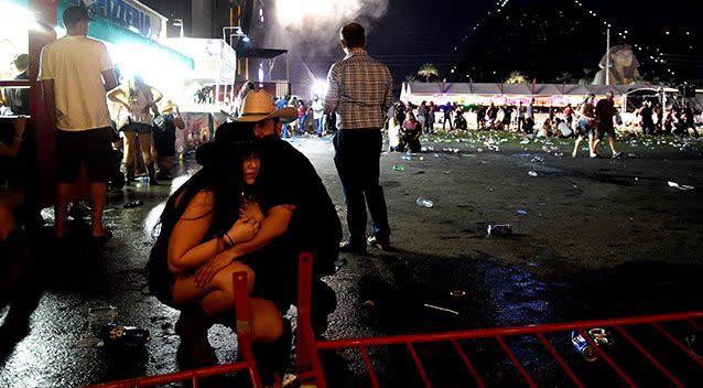 Terrified festivalgoers duck for cover as gunfire hails down. Source: Getty Images