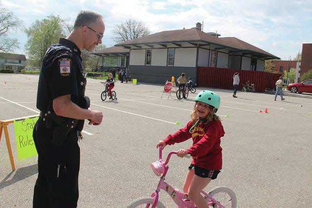 Officer Monte Keller explains the rules of the road during a past Safety Bike Rodeo in Adel.