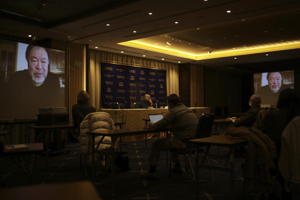 Journalists and guests listen to Chinese artist Ai Weiwei, on screen, speaking from Lisbon, Portugal, during a virtual news conference at the Foreign Corespondents' Club of Japan in Tokyo Friday, Jan. 22, 2021. Ai said that his latest documentary “Coronation” has been refused to be exhibited at major film festivals and online TV platforms due to its sensitivity. (AP Photo/Hiro Komae)