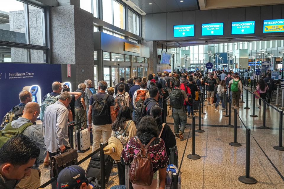 Travelers wait in a security line at Austin-Bergstrom International Airport on Monday, Oct. 23, 2023 in Austin.