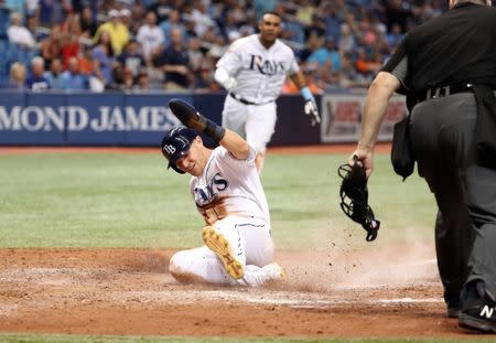 Jul 9, 2018; St. Petersburg, FL, USA; Tampa Bay Rays first baseman Jake Bauers (9) slides safe into home plate as he scores during the seventh inning against the Detroit Tigers at Tropicana Field. Mandatory Credit: Kim Klement-USA TODAY Sports