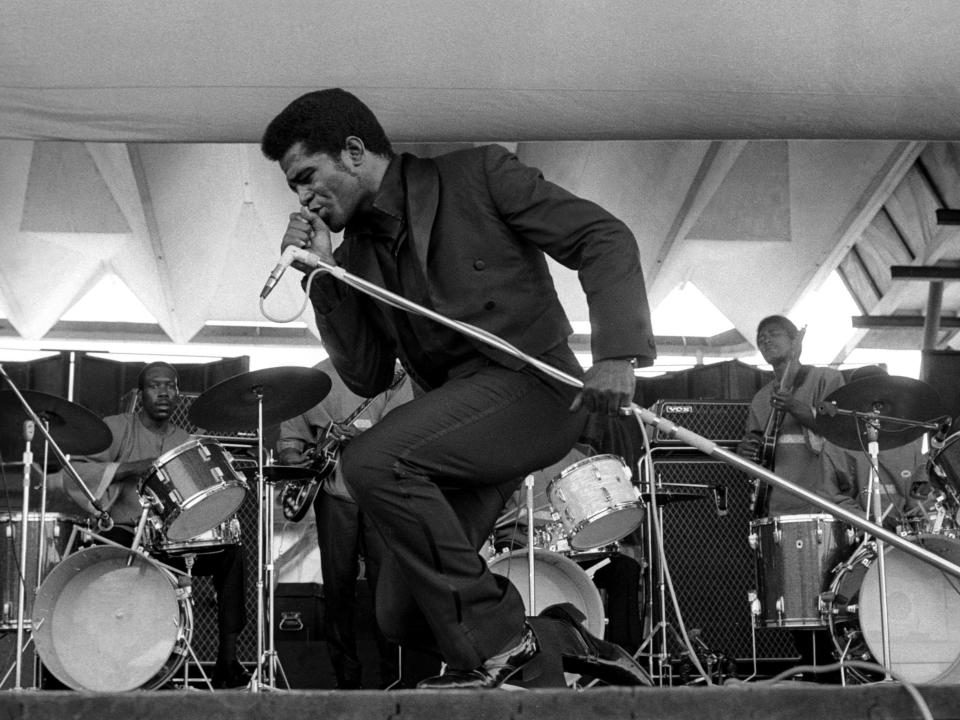 A photo of James Brown performing onstage.
