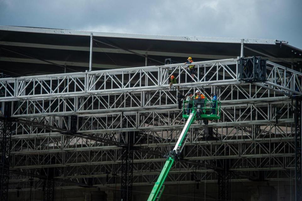 A construction crew works on the trusses over the giant stage being built for the NFL Draft activities on Thursday, April 20, 2023, in Kansas City.