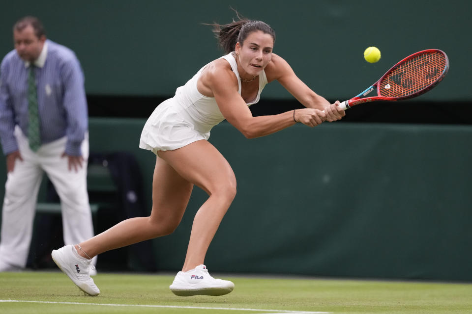 Emma Navarro of the United States plays a backhand return to Naomi Osaka of Japan during their match on day three at the Wimbledon tennis championships in London, Wednesday, July 3, 2024. (AP Photo/Alberto Pezzali)