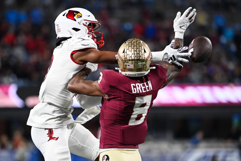 Dec 2, 2023; Charlotte, NC, USA; Florida State Seminoles defensive back Renardo Green (8) breaks up a pass intended for Louisville Cardinals wide receiver Jadon Thompson (2) in the third quarter at Bank of America Stadium. Mandatory Credit: Bob Donnan-USA TODAY Sports