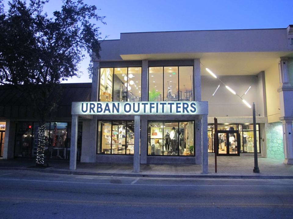 Urban Outfitters store as seen from front on empty street at dusk.